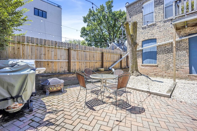 view of patio featuring area for grilling and a fire pit