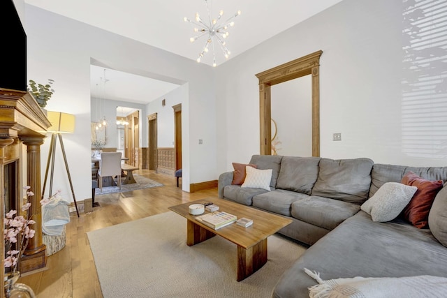 living room with a notable chandelier and light hardwood / wood-style floors