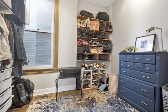 spacious closet with dark hardwood / wood-style floors