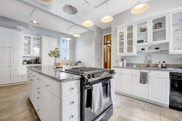 kitchen featuring black appliances, sink, light stone countertops, decorative light fixtures, and white cabinetry