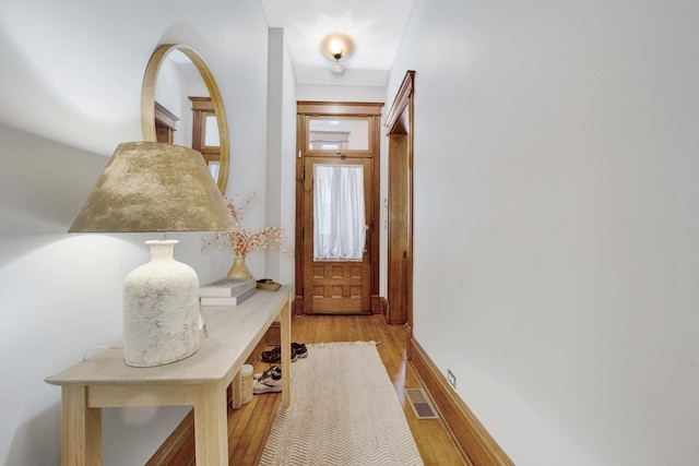 mudroom with light hardwood / wood-style floors