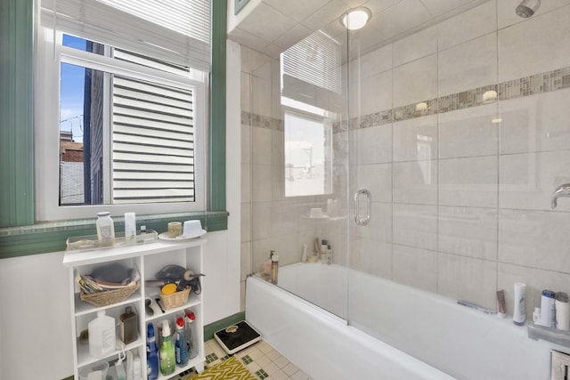 bathroom with tile patterned flooring and combined bath / shower with glass door