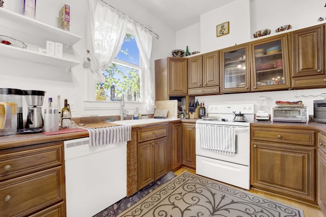 kitchen featuring dishwashing machine, sink, and white electric stove