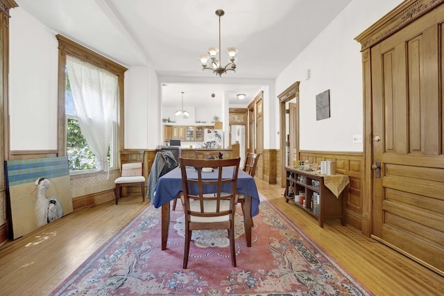 dining area with a chandelier and light hardwood / wood-style floors