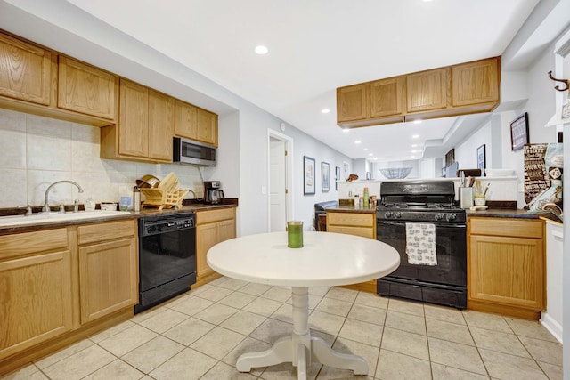 kitchen with decorative backsplash, sink, light tile patterned flooring, and black appliances