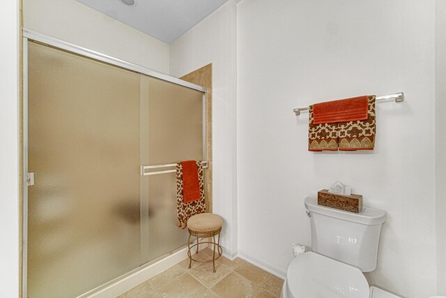 bathroom with walk in shower and toilet