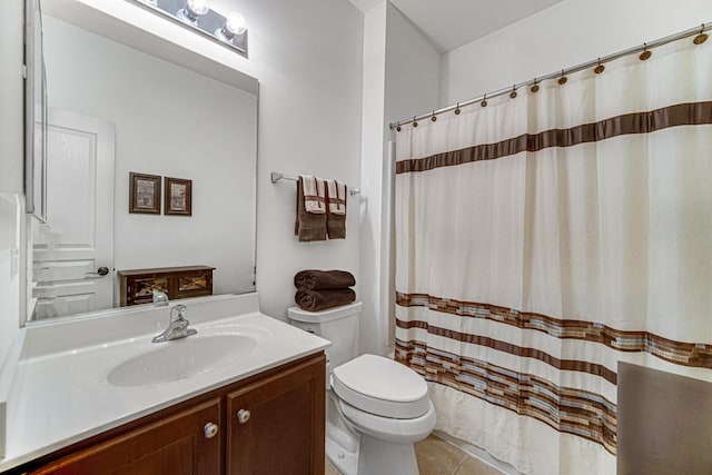 bathroom featuring tile patterned floors, walk in shower, vanity, and toilet