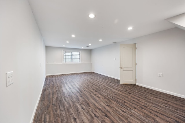 empty room with dark hardwood / wood-style flooring