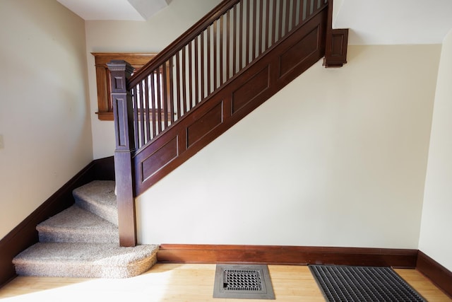 stairway featuring hardwood / wood-style flooring