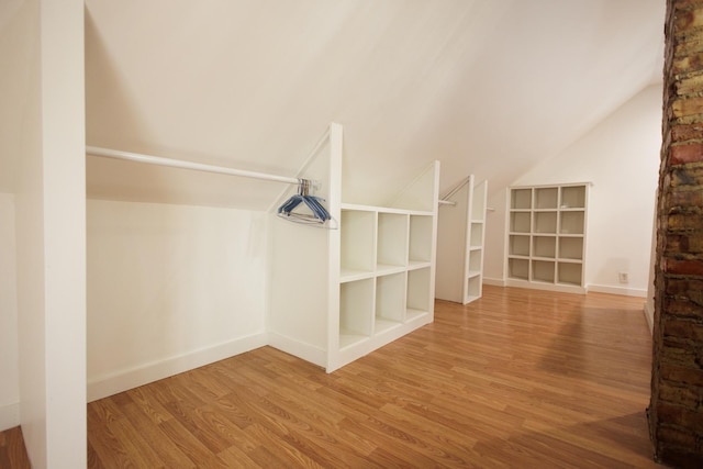 spacious closet featuring hardwood / wood-style flooring and lofted ceiling