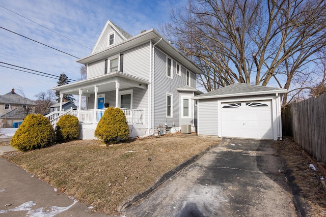 view of front of home featuring covered porch, central air condition unit, an outbuilding, and a garage