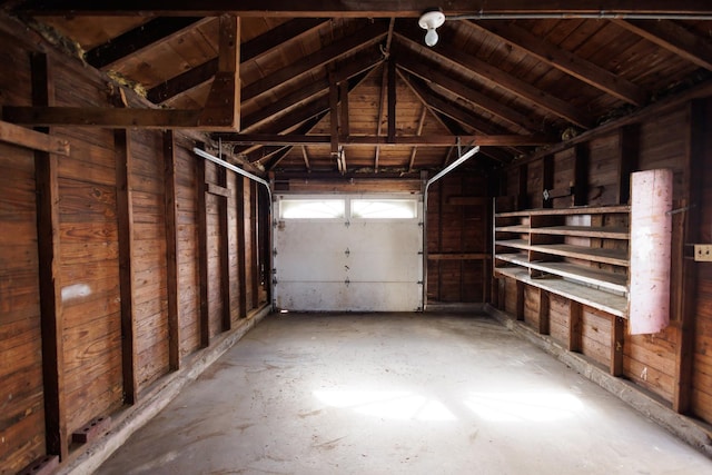 garage featuring wood ceiling and wood walls