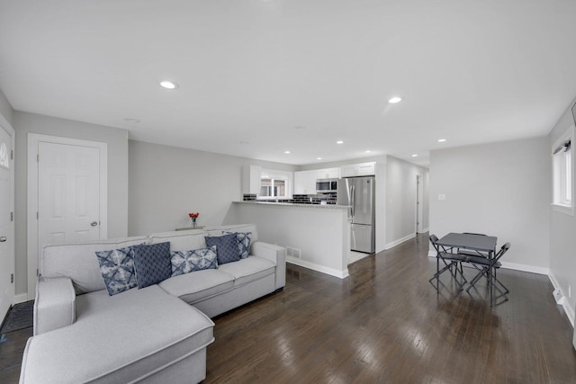 living room featuring dark wood-type flooring