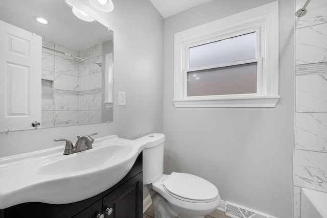 full bathroom with vanity, toilet, and tiled shower / bath combo