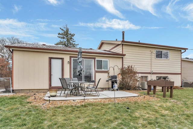 rear view of property with a patio and a lawn