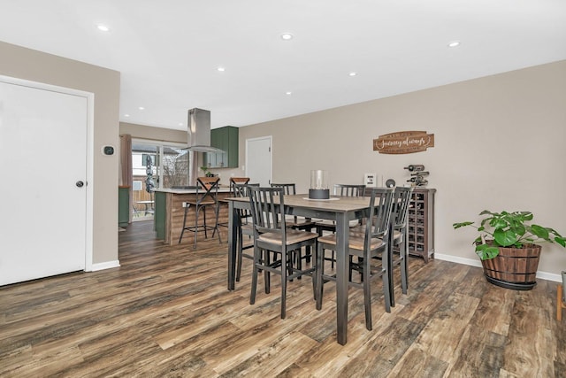 dining space with hardwood / wood-style floors