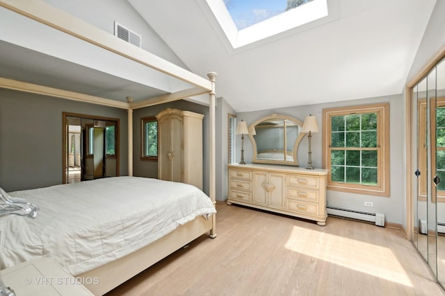 bedroom featuring light hardwood / wood-style floors, lofted ceiling with skylight, and a baseboard heating unit