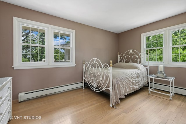 bedroom featuring light hardwood / wood-style flooring and baseboard heating