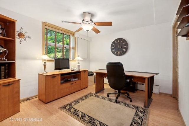 home office with ceiling fan, a baseboard heating unit, and light hardwood / wood-style flooring