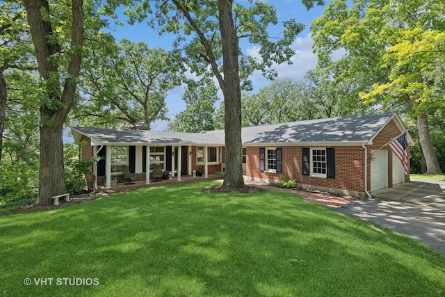 single story home featuring a front lawn, covered porch, and a garage