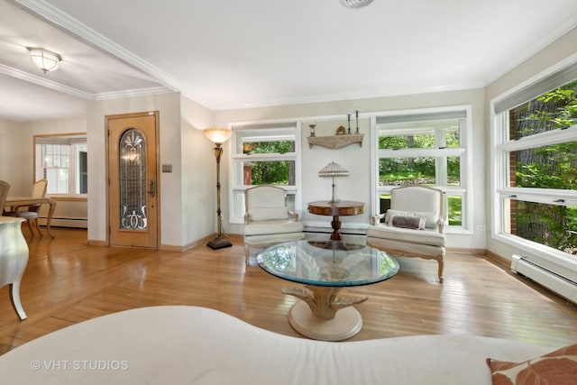 living room with light hardwood / wood-style flooring, a baseboard heating unit, and ornamental molding