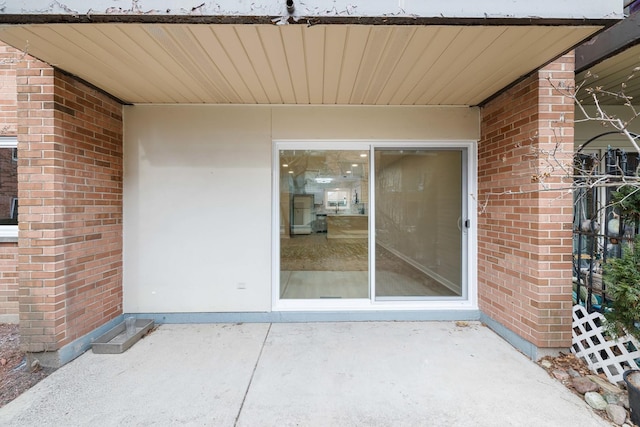 property entrance featuring a patio area