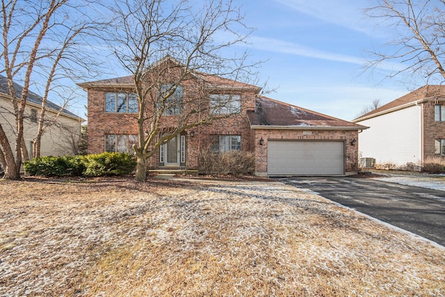 view of front property with cooling unit and a garage