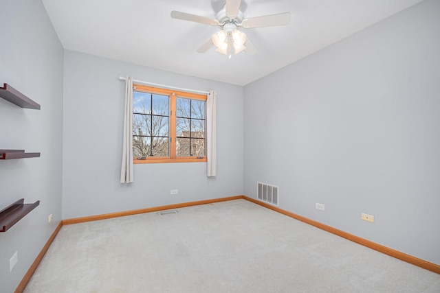 spare room with ceiling fan and carpet floors