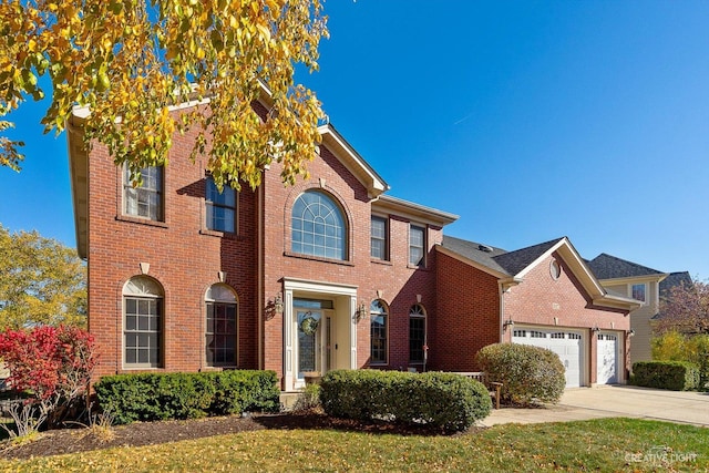 view of front of property featuring a front yard and a garage