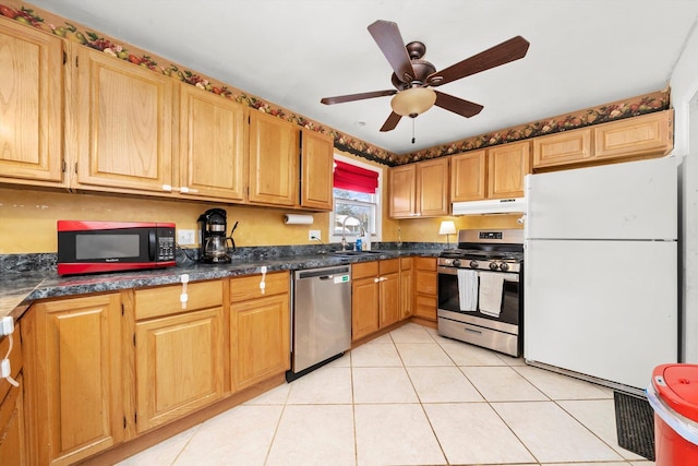 kitchen with light tile patterned floors, appliances with stainless steel finishes, ceiling fan, and sink