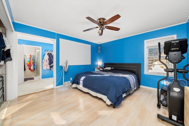 bedroom with ceiling fan, crown molding, ensuite bathroom, and light hardwood / wood-style floors