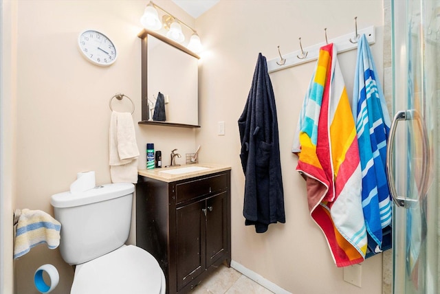 bathroom featuring toilet, vanity, and tile patterned flooring