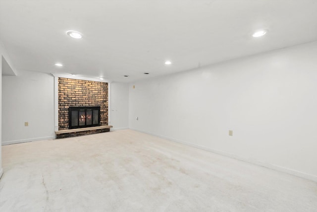 unfurnished living room with light colored carpet and a fireplace