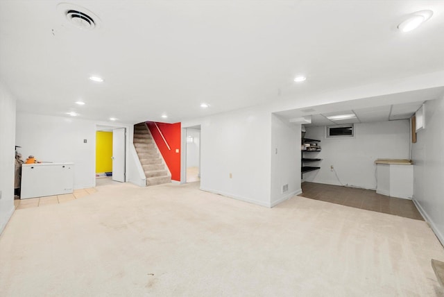 basement featuring light carpet