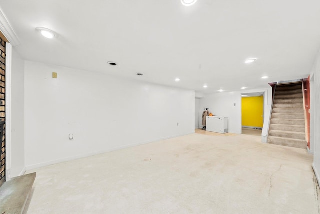 basement featuring light colored carpet