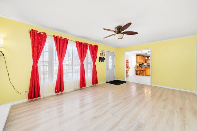 foyer with light hardwood / wood-style floors and ceiling fan