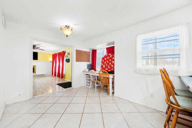 tiled dining room with ceiling fan and a healthy amount of sunlight