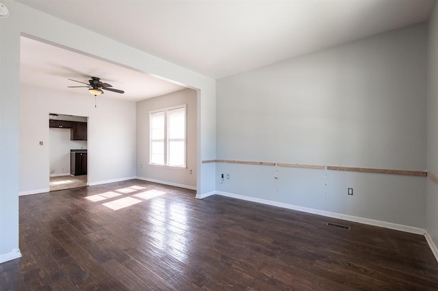 unfurnished living room with ceiling fan and dark hardwood / wood-style floors