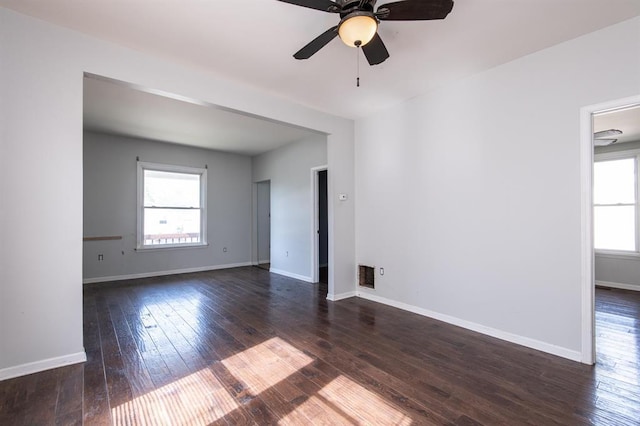 empty room with dark hardwood / wood-style flooring and ceiling fan