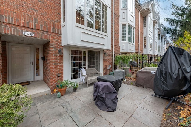 view of patio / terrace with cooling unit and a grill