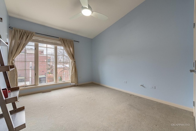 carpeted empty room with ceiling fan and vaulted ceiling