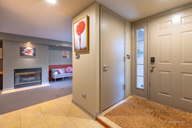 view of carpeted foyer entrance