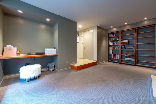 interior space with built in desk and carpet flooring