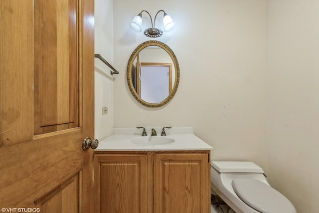 bathroom featuring toilet and vanity