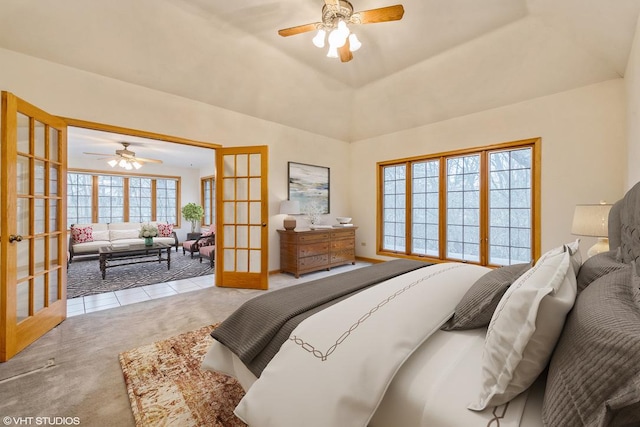 carpeted bedroom featuring vaulted ceiling and french doors