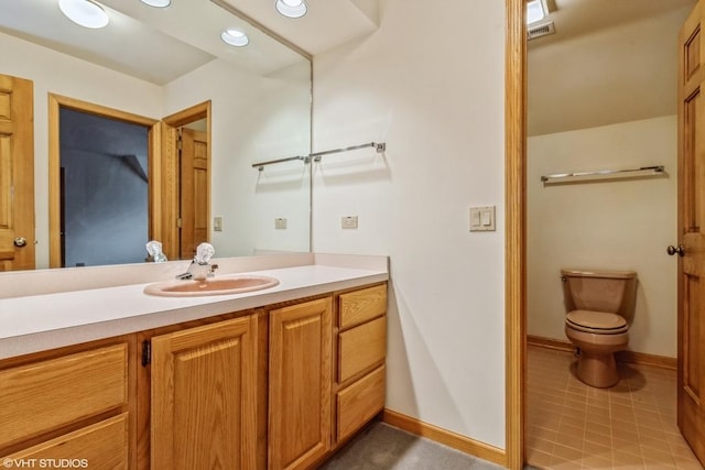 bathroom featuring toilet and vanity