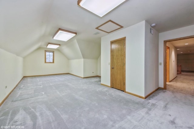 additional living space featuring light carpet and lofted ceiling