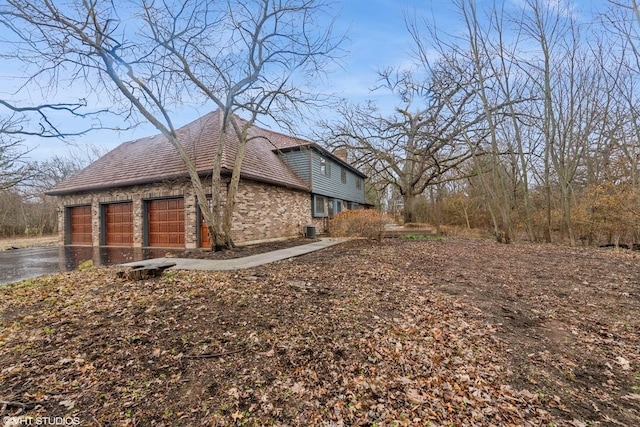 view of side of property with a garage