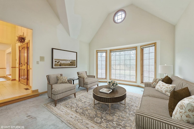 living room featuring carpet floors and high vaulted ceiling