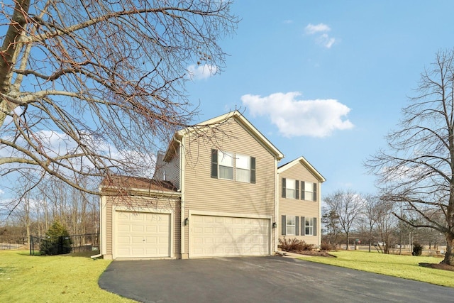 view of front of house featuring a garage and a front lawn